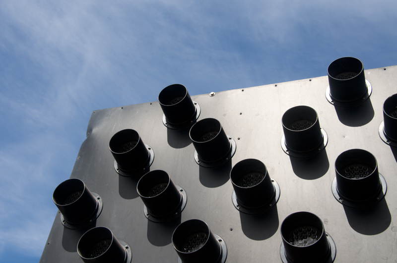 Weathered arrow sign pointing to a roadside attraction