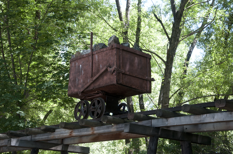 Old mine cart on tracks in deserted mining area