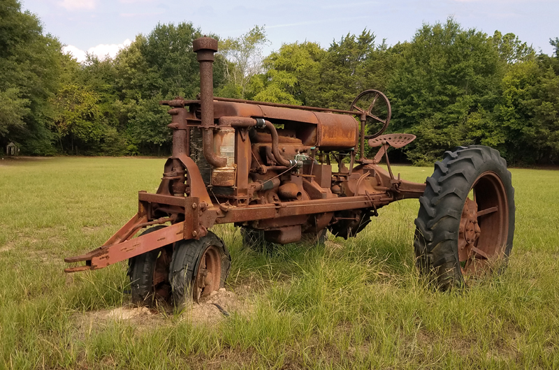 Old tractor parked in rural setting