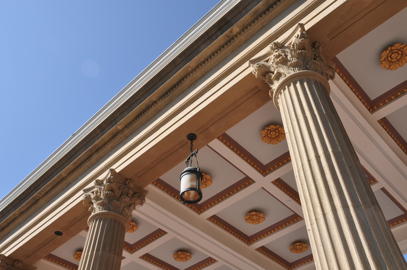 Stone pillars casting long shadows in sunlight
