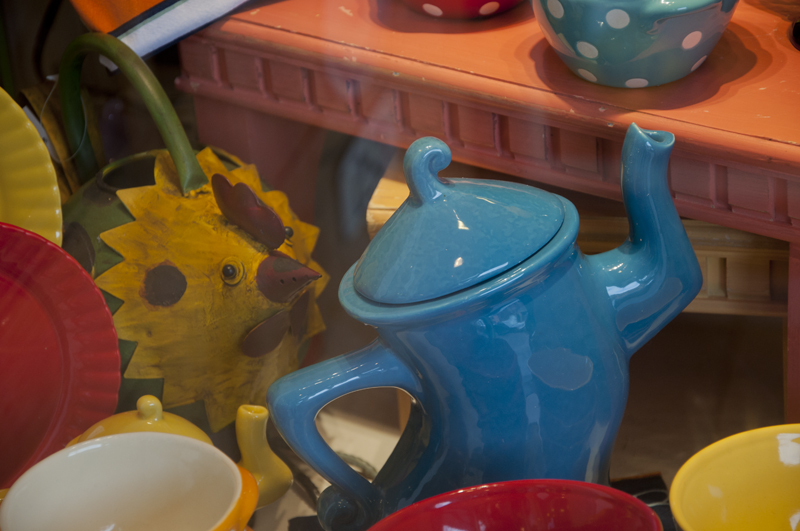 Quirky teapot sculpture in outdoor setting