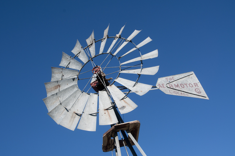 Windmill standing tall in open plains